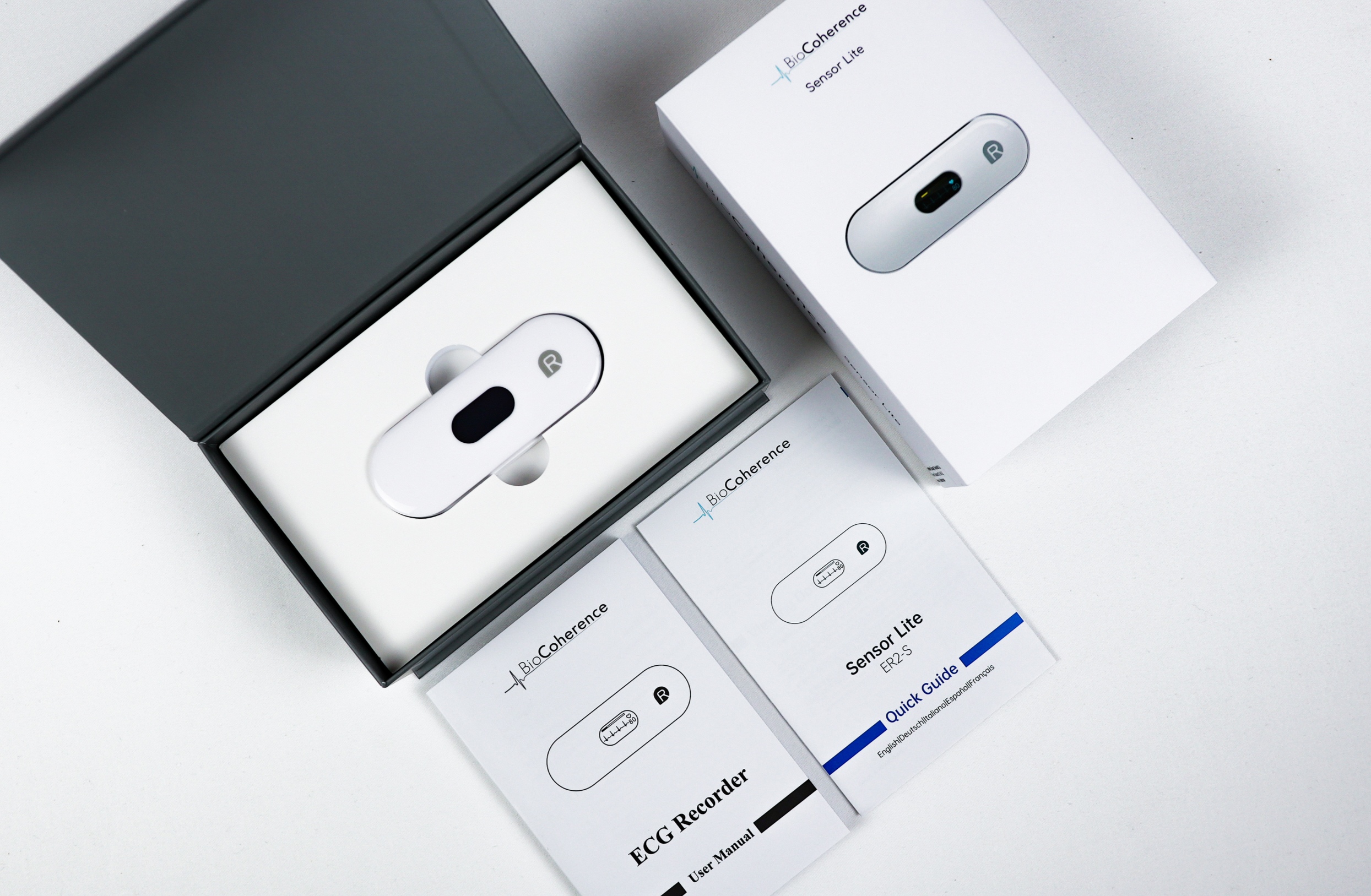 The BioCoherence Sensor Lite ECG recorder with its box, user manual, and quick-start guide